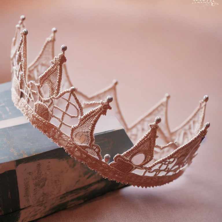 Rose Gold Tiara with Lace Filigree and Bead Accents on Vintage Books Against Blush