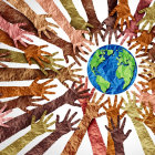 Diverse human hands united around central globe symbolizing unity