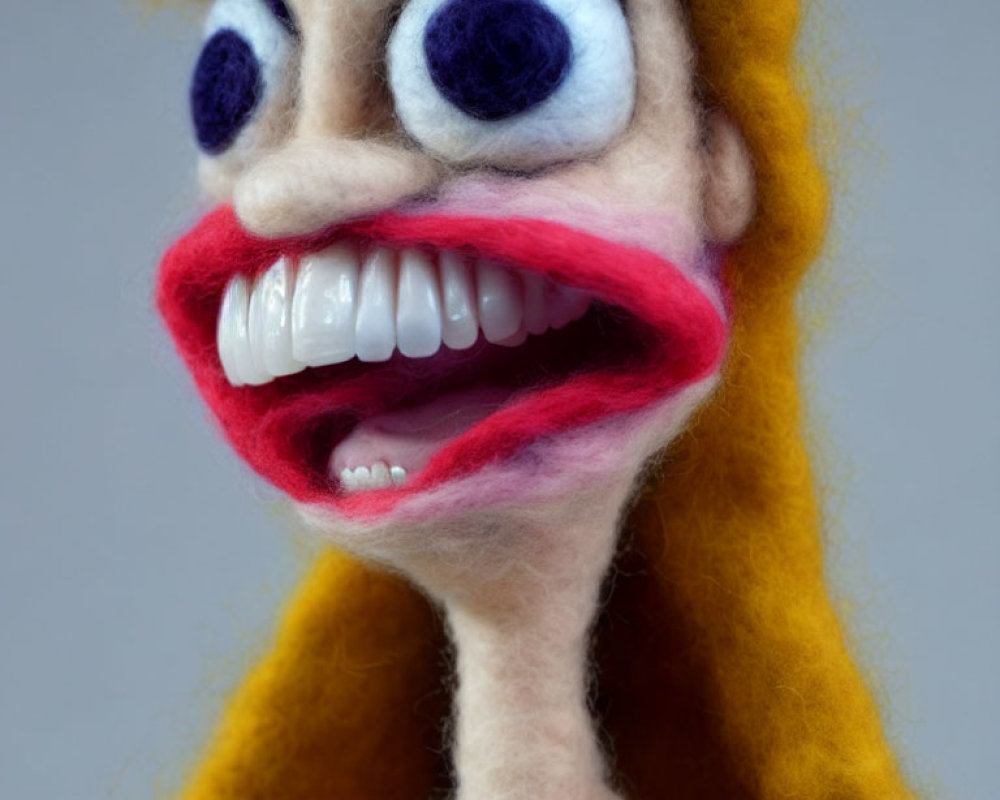 Exaggerated features on felted fabric puppet: large blue eyes, oversized red lips, and prominent