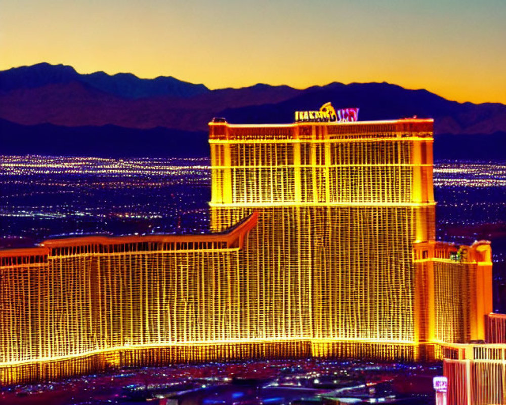 Golden hotel shines in Las Vegas twilight skyline