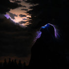 Silhouette of person with glowing hair gazing at moonlit night sky