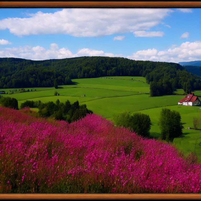 Scenic landscape with lush green field, trees, house, and pink flowers under blue sky