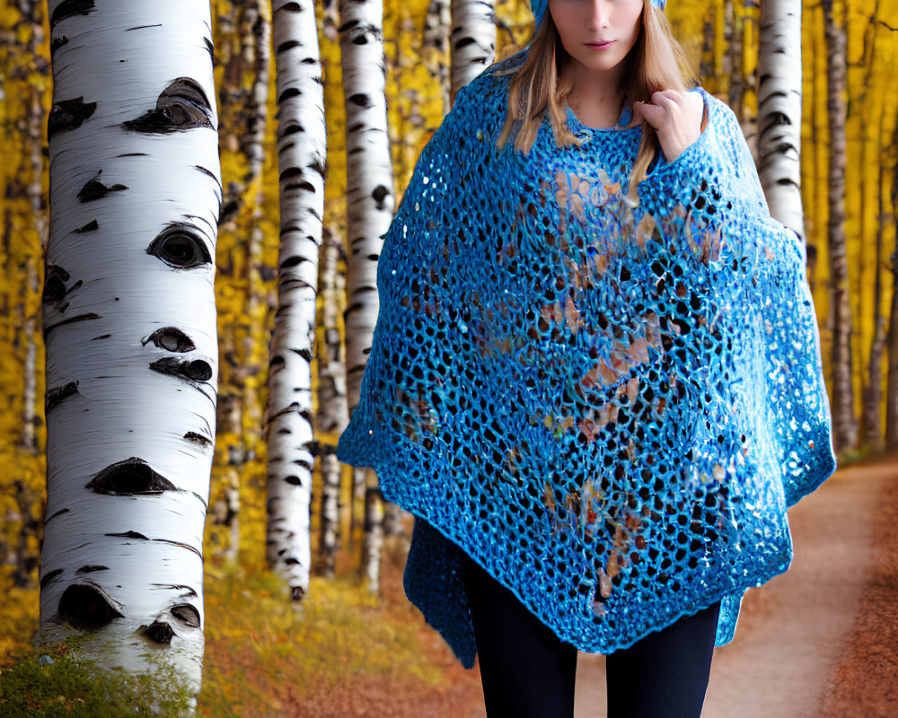 Woman in Blue Knitted Hat and Shawl on Forest Path with Autumn Leaves