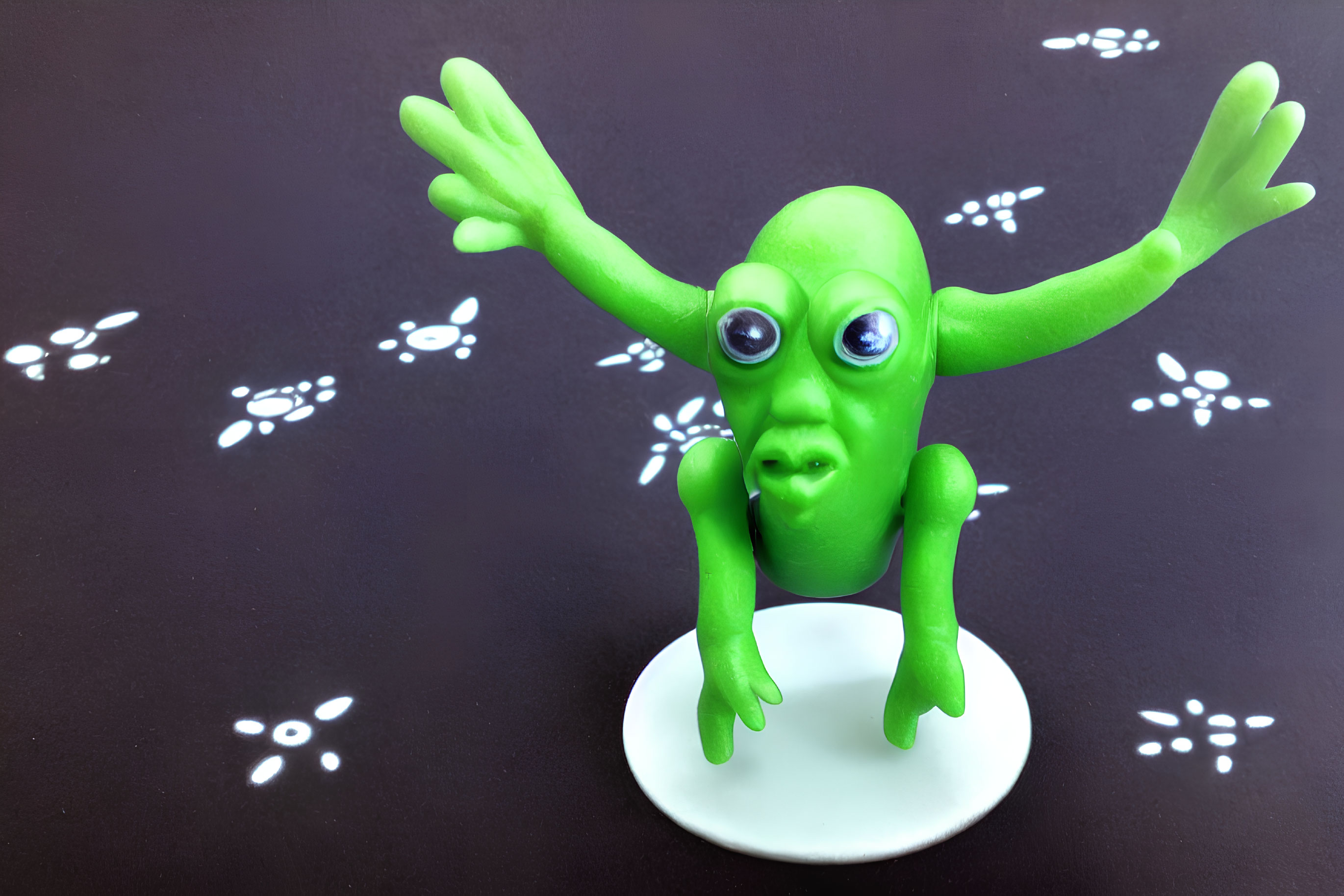 Green Alien Figurine with Large Eyes and Outstretched Arms on White Stand against Black Background