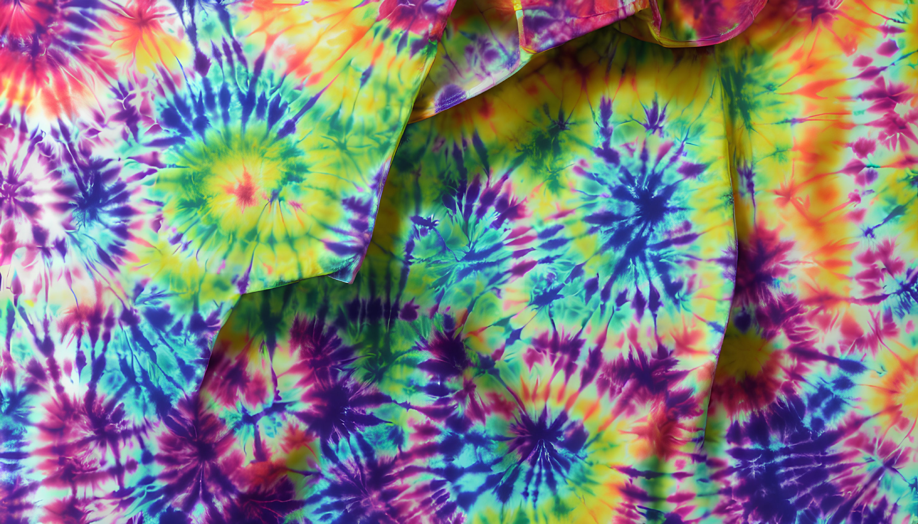 Colorful Tie-Dye Fabric with Circular Patterns in Blue, Green, Yellow, and Pink