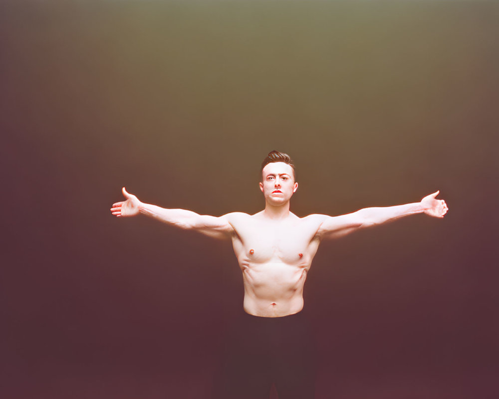 Shirtless Man with Extended Arms in Soft Warm Light