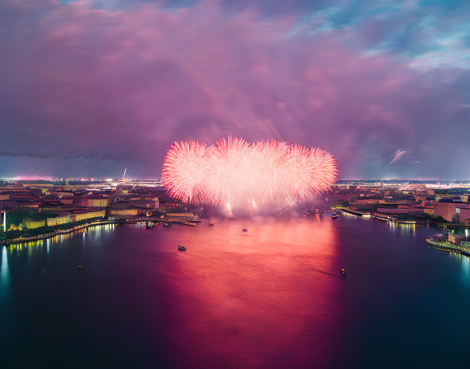 Colorful fireworks display over city waterfront at night