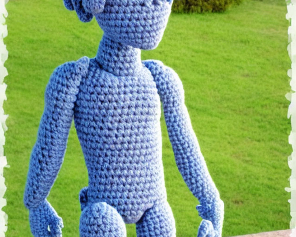 Knitted figure with curly blue head standing on brown ledge