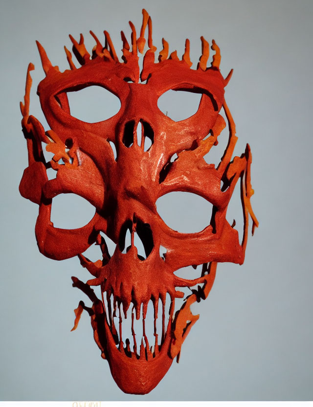 Red Flame-Like Design Mask with Large Eye Openings on Pale Background
