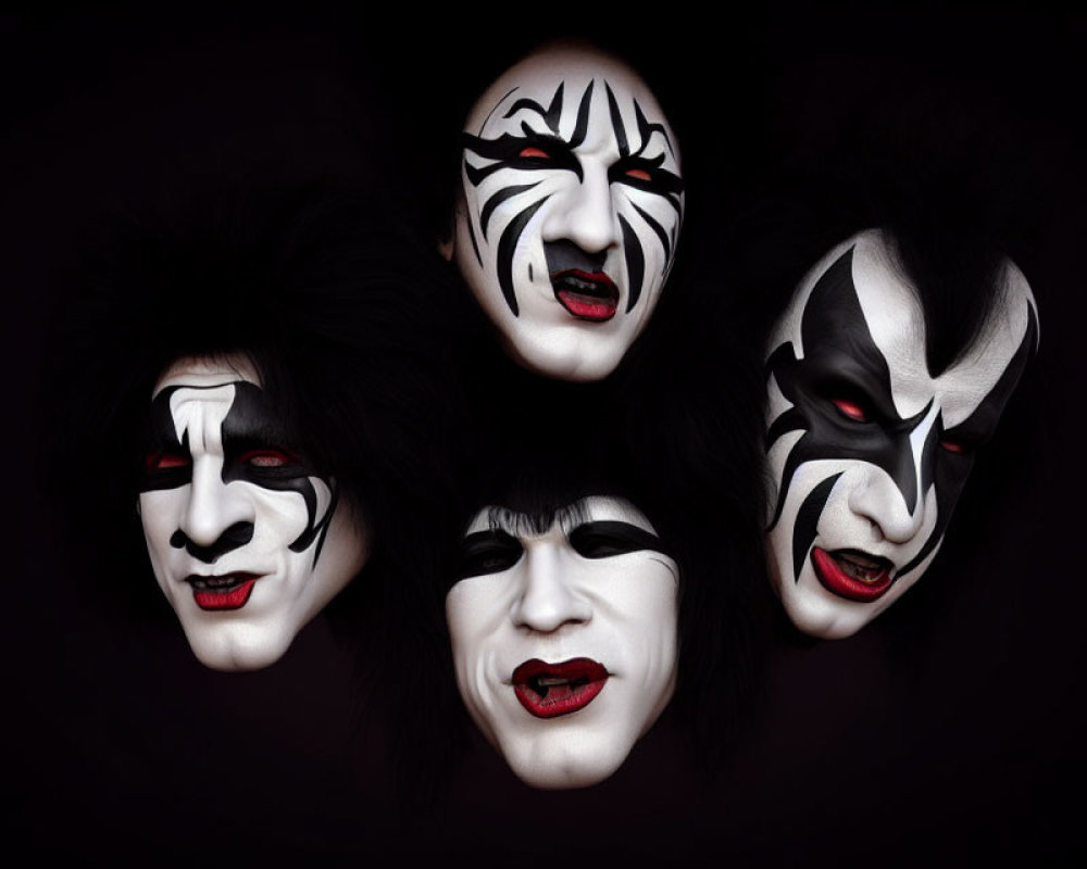 Four individuals in black and white face paint on dark background