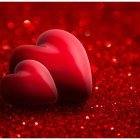 Red Heart Shapes on Sparkling Background with Scattered Hearts