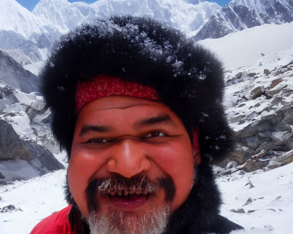 Smiling person in snow with fur hat and red bandana