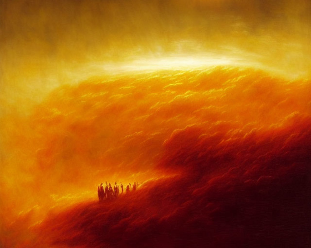 Silhouetted figures on hill overlooking fiery landscape at sunset