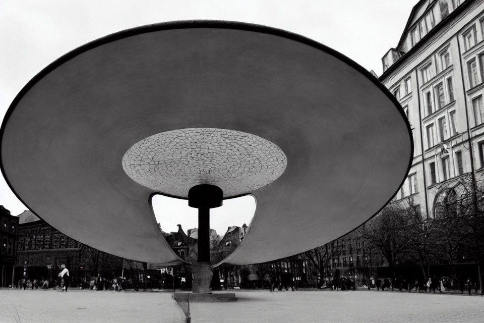 Monochrome urban square with large funnel sculpture