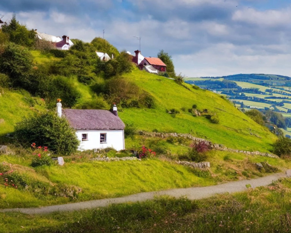 White cottages, red roofs on green hills under blue sky