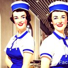 Vintage Flight Attendants in Airplane Cabin Uniforms.