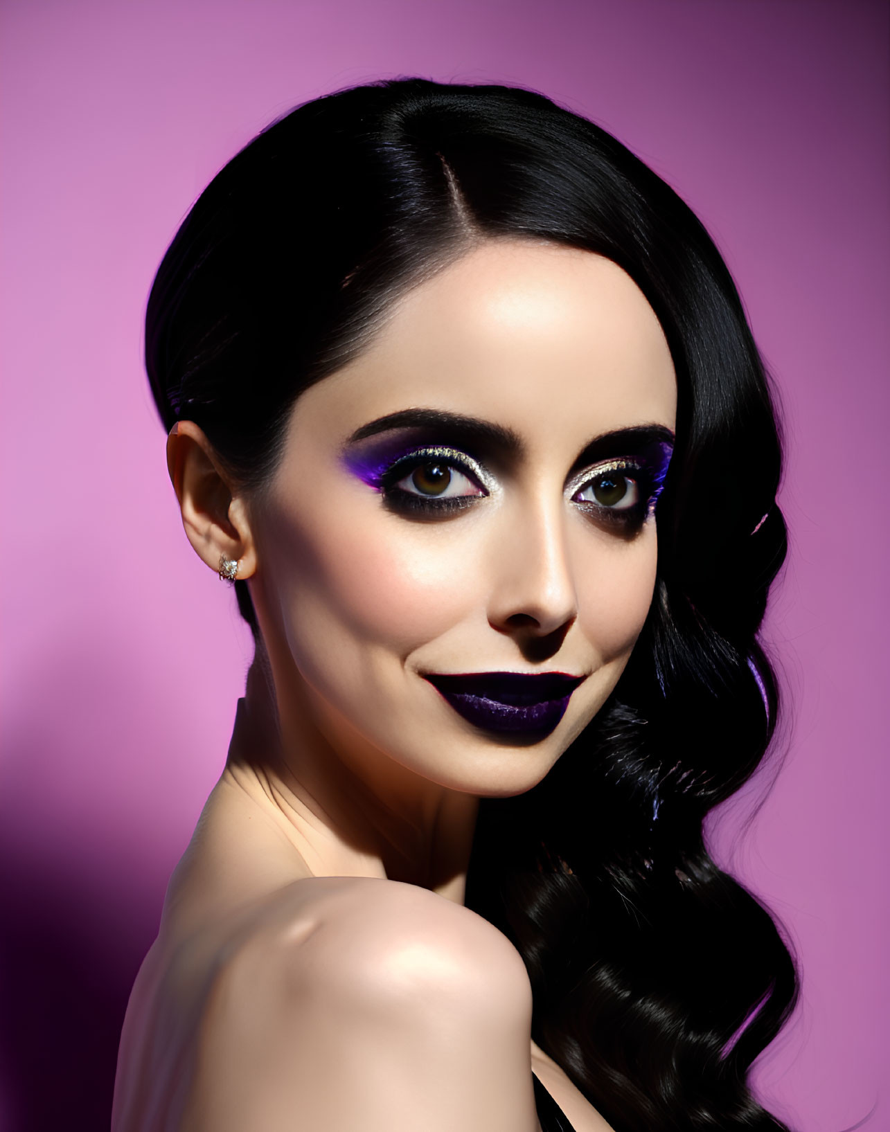 Dark-haired woman with bold purple makeup on purple background