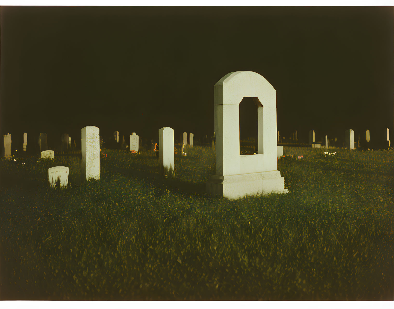 Cemetery Night Scene with Tombstones and Arch-shaped Headstone