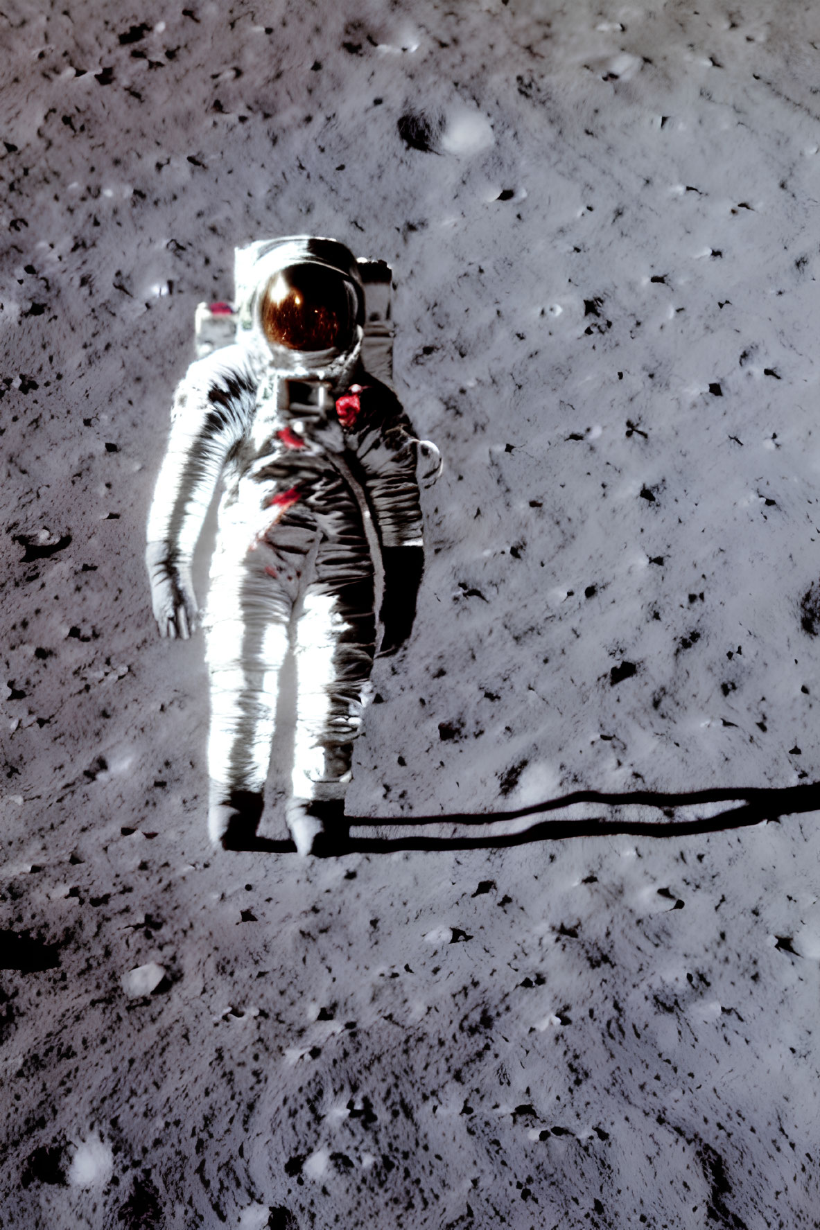 Astronaut in reflective space suit on lunar surface with Earth in background