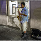 Man in Blue Suit Playing Saxophone in Vintage Street Scene