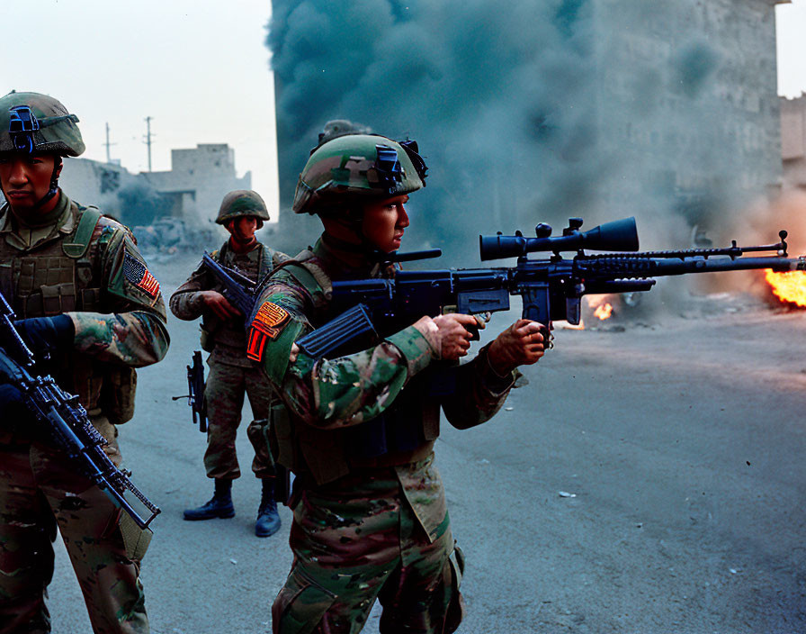 Military soldiers patrolling near fire with rifle and grenade launcher.