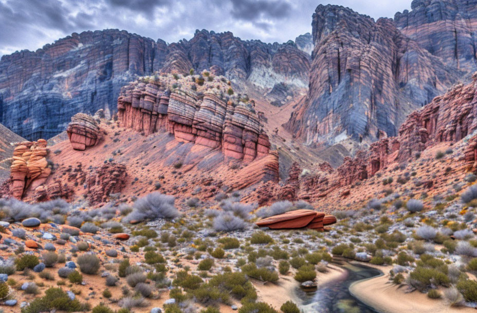 Scenic desert landscape with red and grey rock formations under cloudy sky