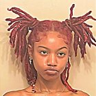 Colorful Dreadlocked Woman with Warm Hues and Thoughtful Gaze