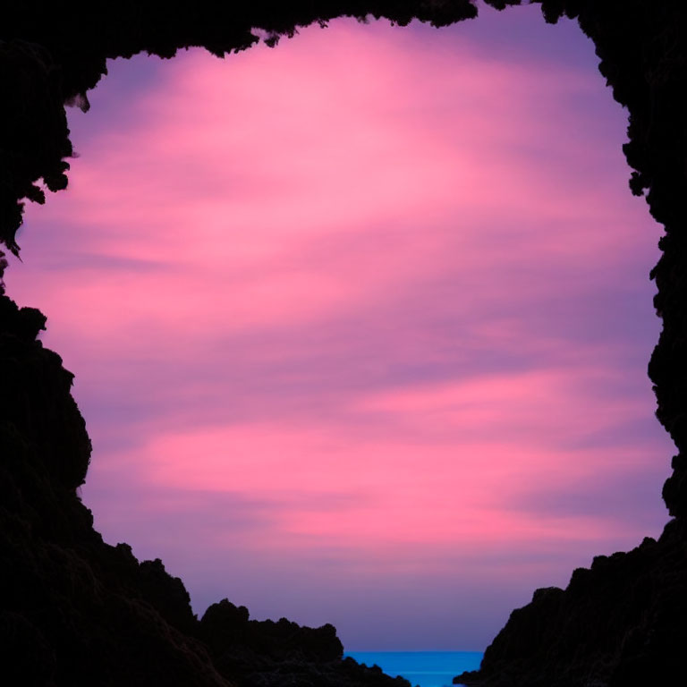 Colorful Pink and Purple Sky Through Cave Silhouette
