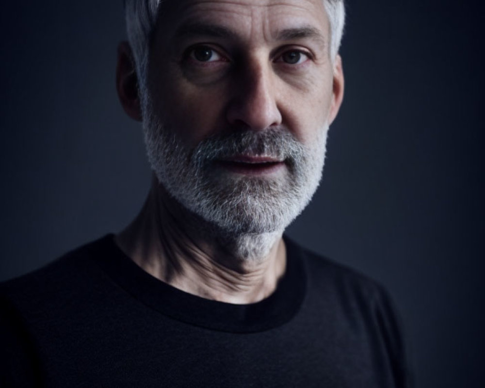 Mature Man with Grey Hair and Beard in Black Shirt Portrait
