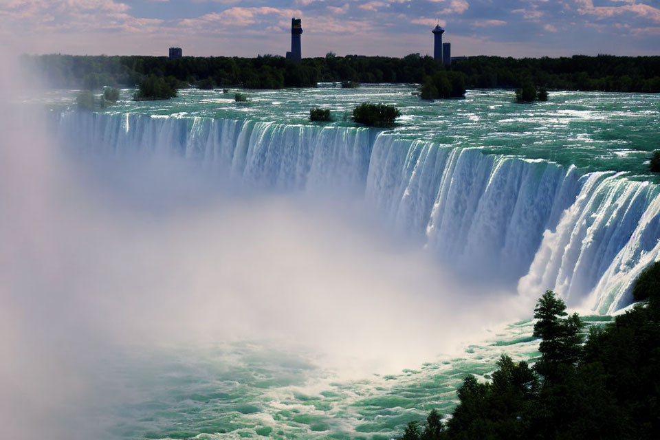 Panoramic view of misty Niagara Falls under clear skies