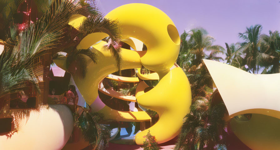Vibrant abstract sculpture with festive decorations in sunny setting.