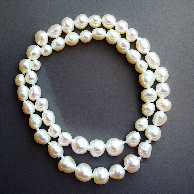 White Pearl Double Strand Loop on Grey Background - Subtle Luster & Smooth Shapes