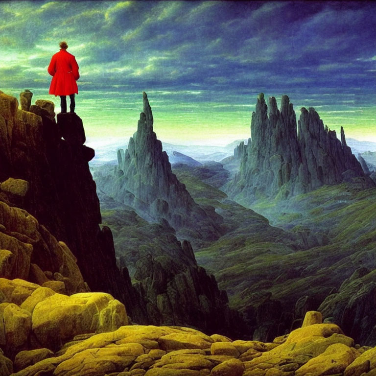 Person in Red Cloak Standing on Rocky Ledge Overlooking Vast Green Landscape