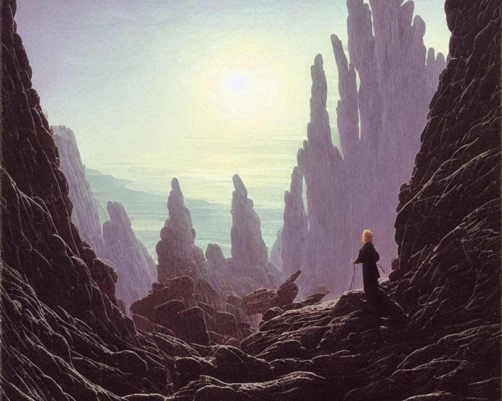 Person gazes at towering spires in rocky gorge under hazy sun