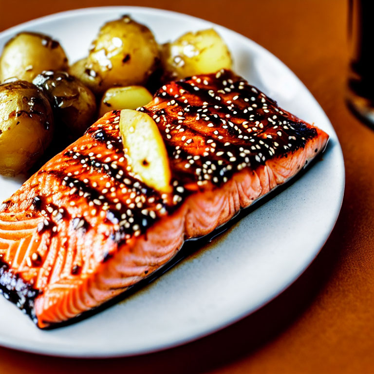 Sesame Glazed Grilled Salmon with Roasted Potatoes on White Plate