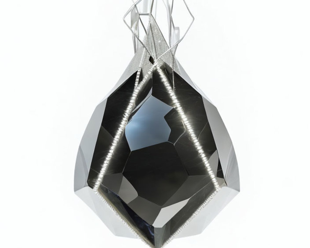 Faceted shiny black crystal with metallic structure on white background