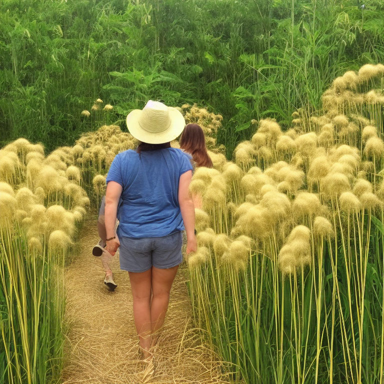 Person in Straw Hat Walking Through Path with Pampas Grass
