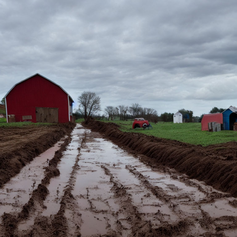 Rural farm scene with muddy road, red barn, truck, and cloudy sky