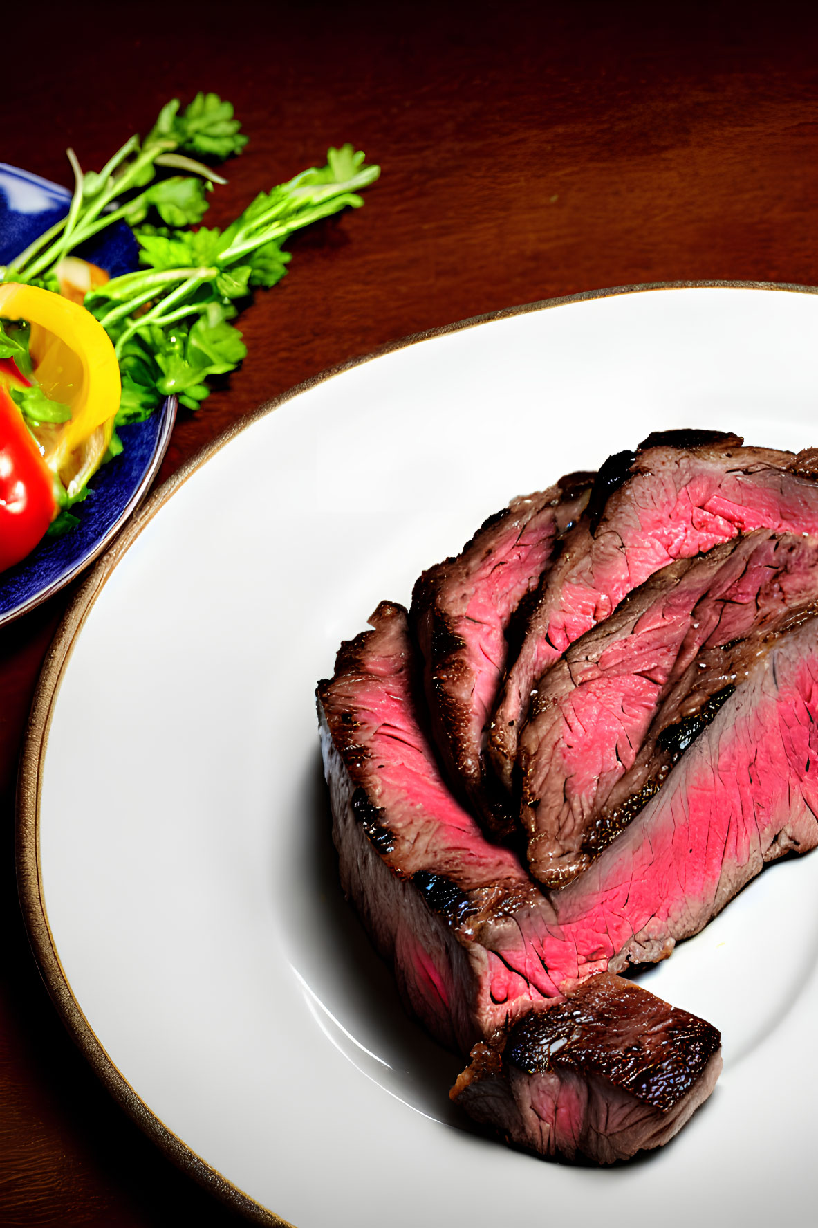 Medium-Rare Steak Slices with Fresh Vegetables on Plate