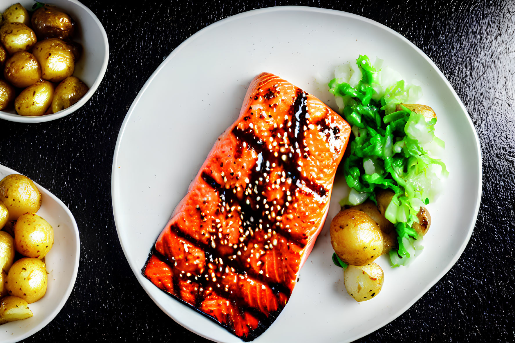 Grilled Salmon Fillet with Sesame Seeds and Roasted Potatoes on White Plate