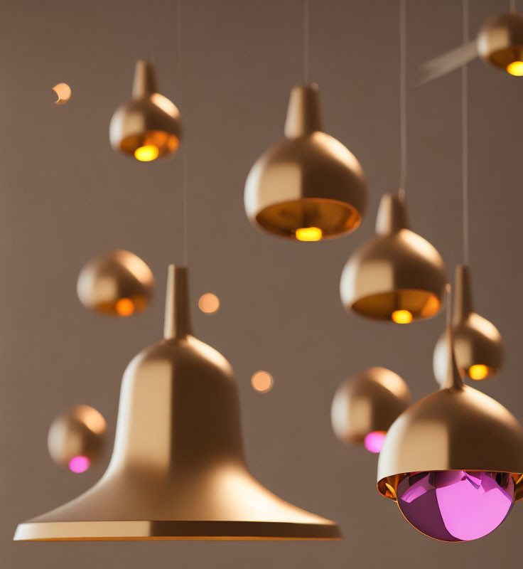Metallic finish modern pendant lights emit warm glow against neutral backdrop.