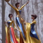 Elegant blue and gold figures with outstretched arms and golden scepter