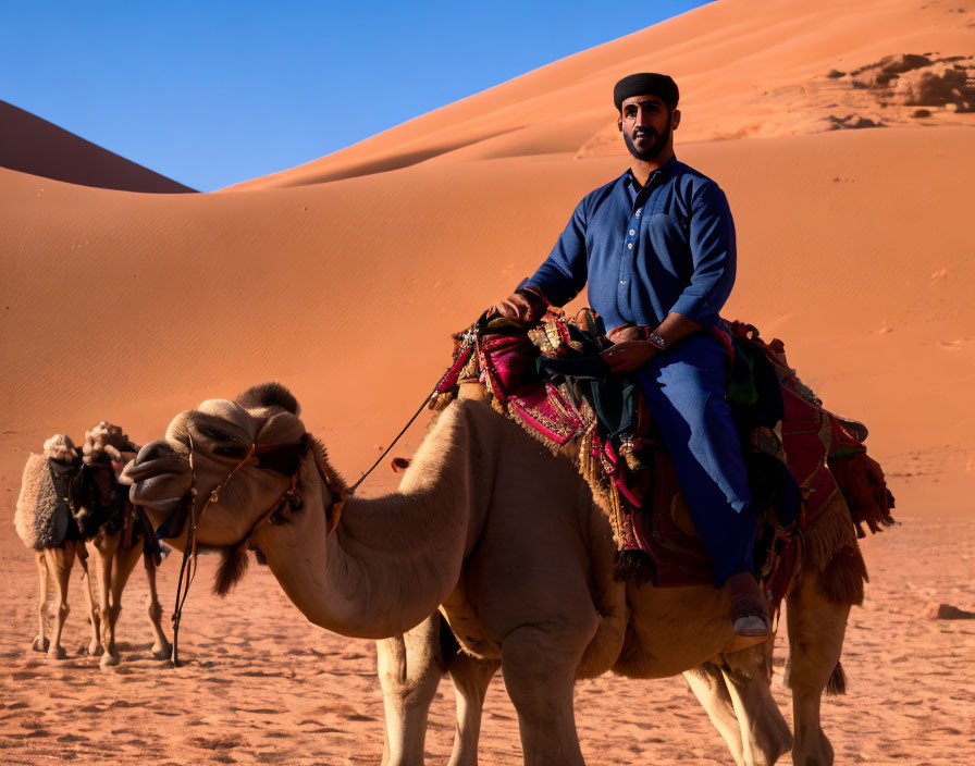 Portrait of an Arab man riding a camel in the dese