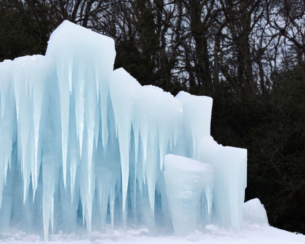 Slender ice formations resembling frozen waterfalls in a dark winter landscape