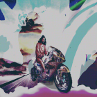 Fantasy-themed artwork featuring a woman on a decorative motorcycle with oversized books, quill pen, and