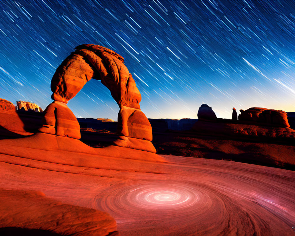 Long-exposure photo of star trails above Delicate Arch with vortex effect
