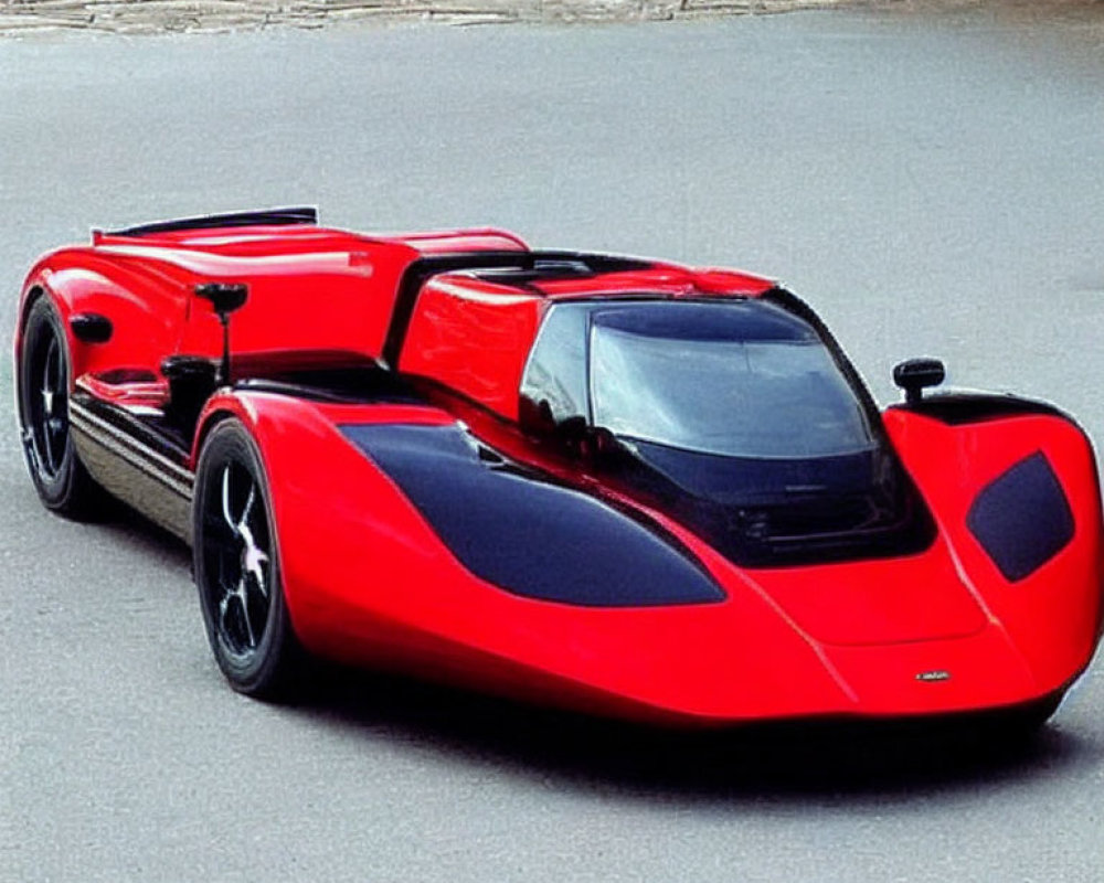 Red and Black Low-Profile Sports Car on Stone-Paved Surface