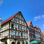 European Half-Timbered Buildings on Street with Flower-Filled Balconies