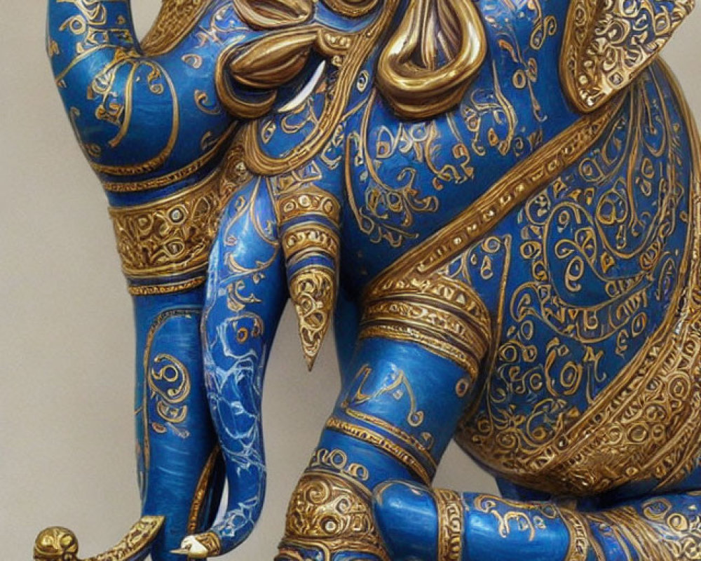 Decorated Elephant Figurine with Gold Patterns on Blue Background