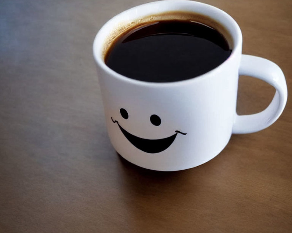White Smiling Face Mug Filled with Black Coffee on Brown Surface